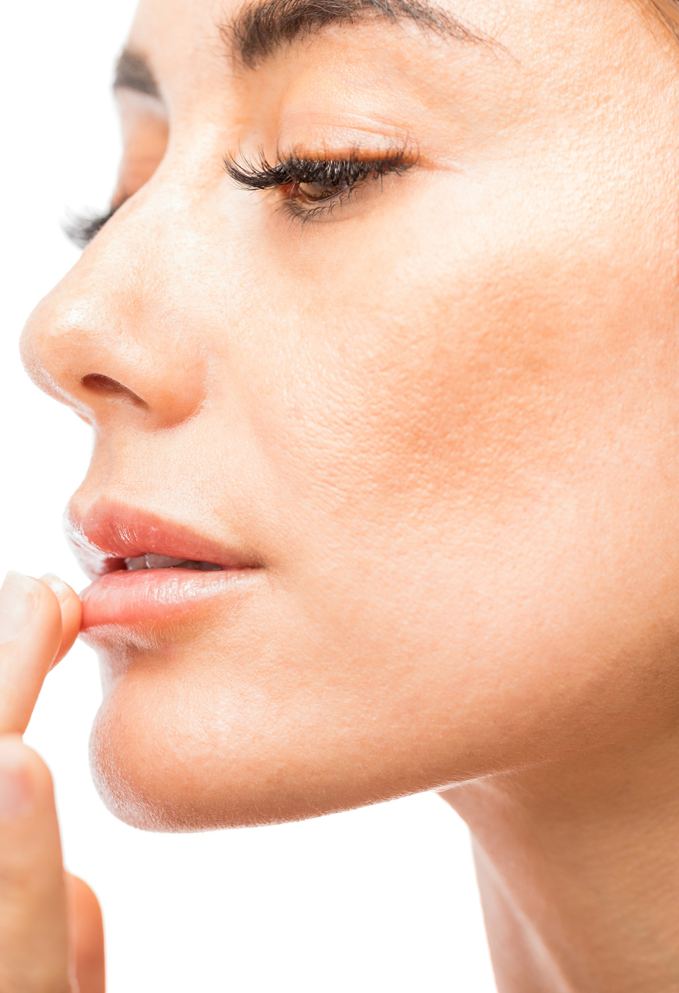 Woman Using Lip Balm In Studio