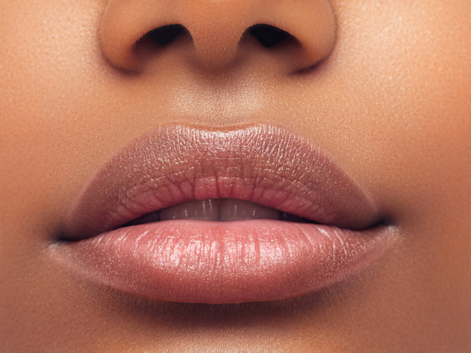 Part of woman's face. Woman's lips and nose. Soft skin